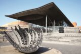 Cardiff, Wales, UK, September 14, 2016 :  The Senedd also known as the National Assembly Building and the Merchant Seafarers' War Memorial both popular visitors attractions of Cardiff Bay